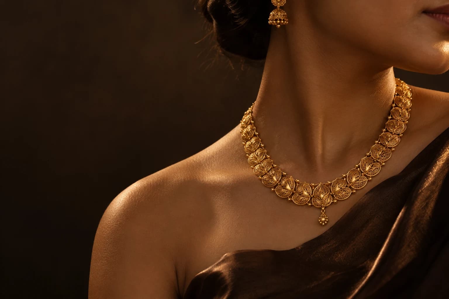An editorial portrait of intricate gold jewelry in the afternoon light
